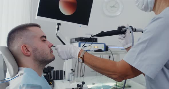An ENT Examines the Patient's Sinuses Using a Medical Mini Camera