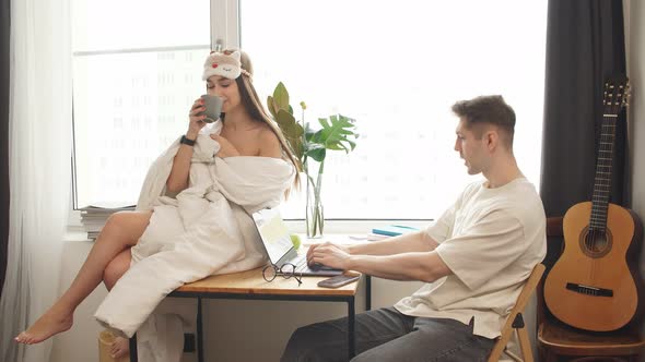 Wife Coquette Only in Blanket Sit on Desk Next To Working Husband