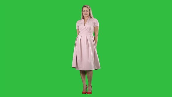 Beautiful lady in pink dress preen on a Green Screen, Chroma Key.