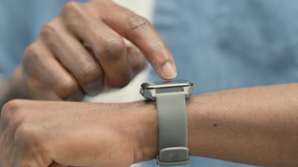 Hands of African Man Using Smartwatch