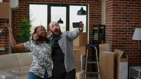 Diverse Married Couple Filming Video in New Rented Household