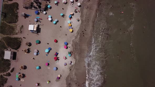 Aerial view of the beach in a hot summer morning, people having fun, enjoying the summer adventures.