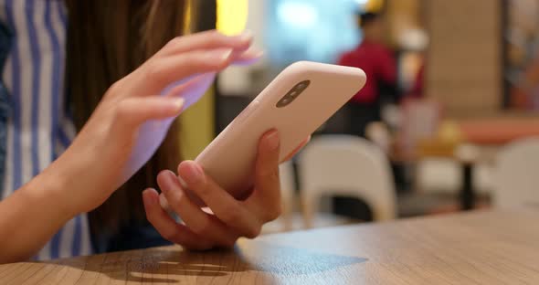Woman use of mobile phone in restaurant 