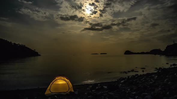 Clouds and the Moon Move Over the Bay and Tent