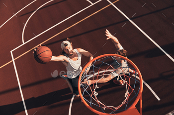 oring a slam dunk while playing basketball outdoors