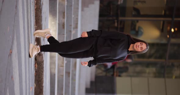 Woman in Black Costume Cross the Road in a City Vertical Video