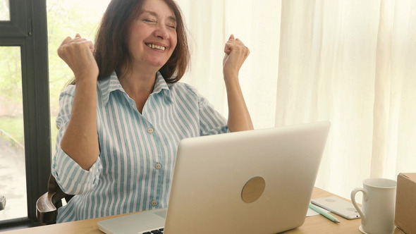 Cheerful Businesswoman with Laptop Celebrating New