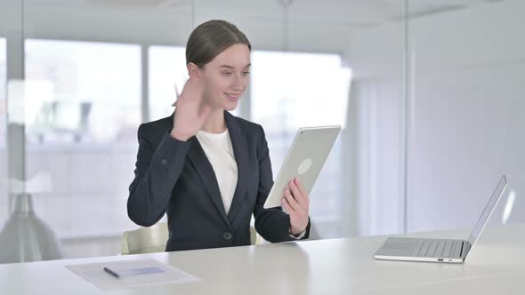 Young Businesswoman Doing Video Chat on Tablet in Office