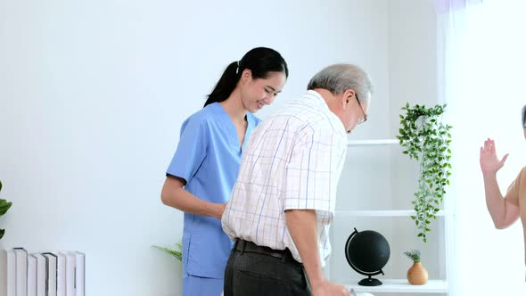 Asian young nurse take care a senior with a walker.