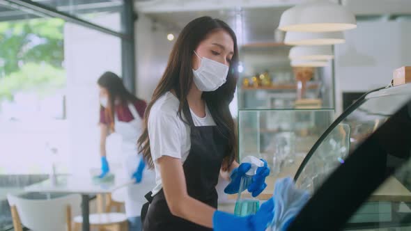 Young Asian female worker woman in mask rubber glova and apron uniform