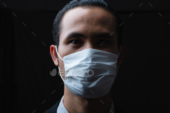 Businessman in suit wearing a face mask, People pay attention to the virus / Photodune, Misc