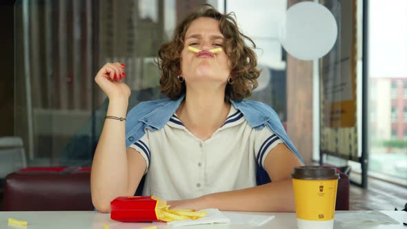 Young Happy Playful Woman Grimace Play with Fries