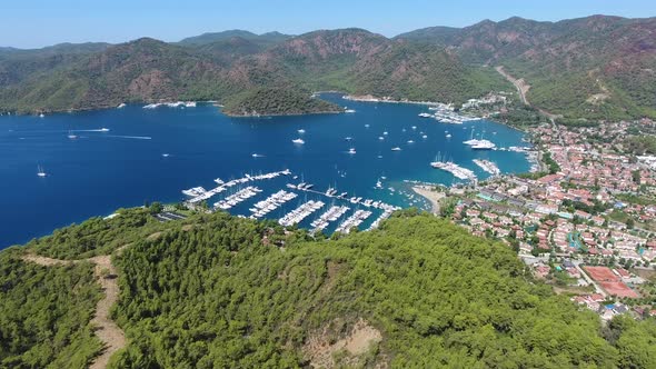 Small City Houses, Beautiful Marina and Touristic Boats in a Cove Surrounded by Forest by Sea