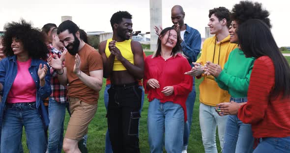 Happy young people dancing at city park outdoor