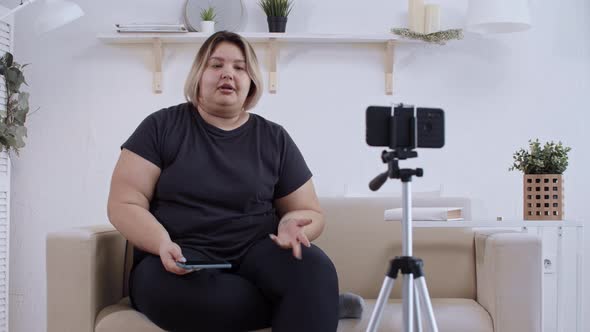 Body Positivity Confident Fat Woman Feminist Lying on a Couch and Making a Video on Her Phone for