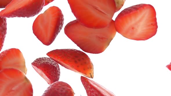 Super Closeup of the Halves of the Fresh Strawberries Falling Diagonally