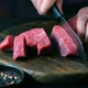 Man cut raw beef on steak pieces - VideoHive Item for Sale