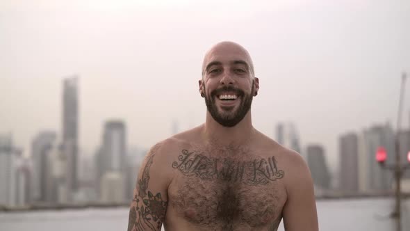 Shirtless Man Smiling As He Gives Both His Thumbs Up