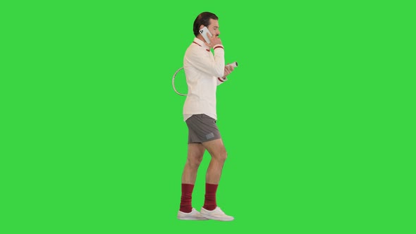 Male Tennis Player Talking Using Smartphone on a Green Screen Chroma Key