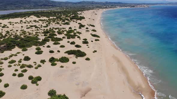 Aerial footage flying across the beach and coastal vacation area called St George South in Corfu