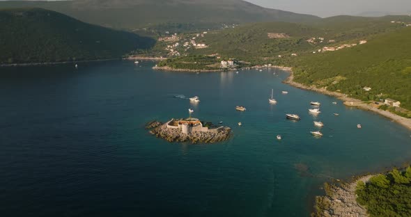 aerial view of Otocic Gospa island and yachts on background