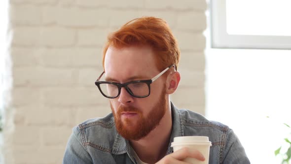 Man w/ Beard, Red Hairs Drinking Coffee, Tea in Office, Portrait