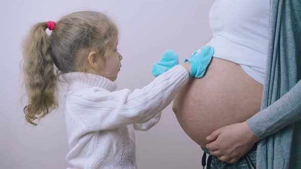 Girl Steps on Pregnant Mommy Tummy with Funny Blue Booties