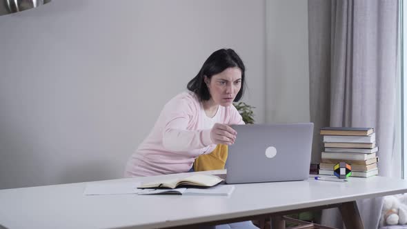 Portrait of Adult Caucasian Woman Opening Laptop and Looking at Screen with Surprised Face. Young