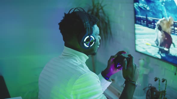 African Black Man Gamer Playing Video Games Using Joystic Controller. Joy and Home Entertainment at