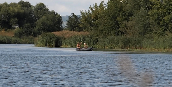 Two Fishermen Go Fishing From A Boat