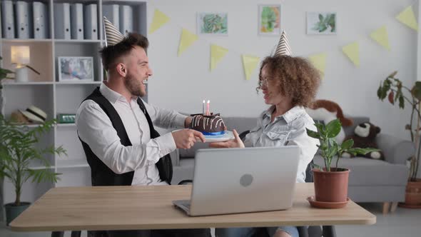 Holiday Online Joyful Young Couple in Holiday Caps Light Candle on the Cake and Talk with Friends