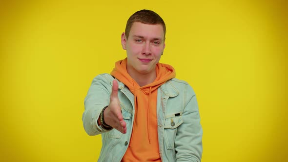 Friendly Man Outstretching Hand to Camera Offering Handshake Greeting with Kind Smile Welcoming