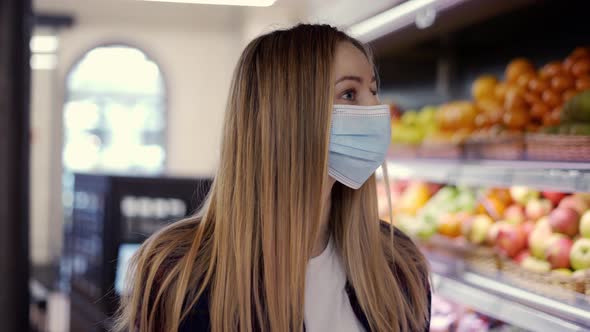 Woman in Protective Mask Looking for Fruits in Supermarket