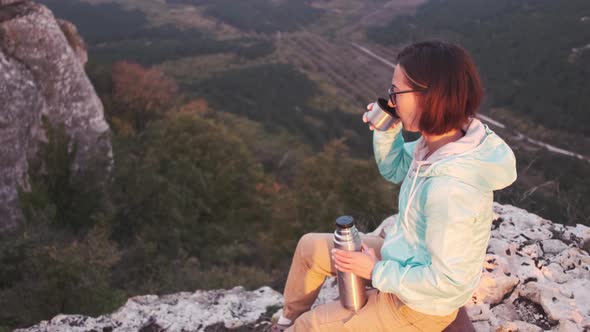 Hiker Woman Relaxing in Mountains and Drinking Tea