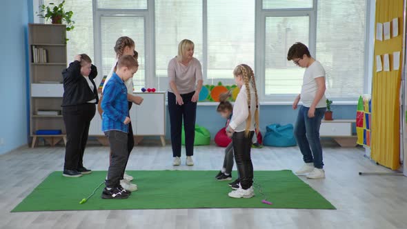 Woman Works As Teacher in an Inclusive School and Conducts Classes for Children with Down Syndrome