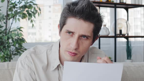 Pensive Serious Focused Businessman Holding Paper Reading Bad News in Mail Letter