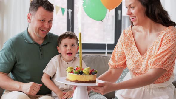 Happy Family with Birthday Cake at Home