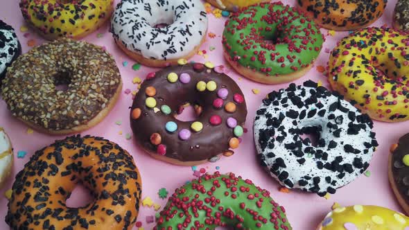 Assorted Donuts with Icing a Pink Background