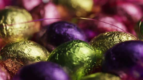 Rotating shot of colorful Easter candies on a bed of easter grass