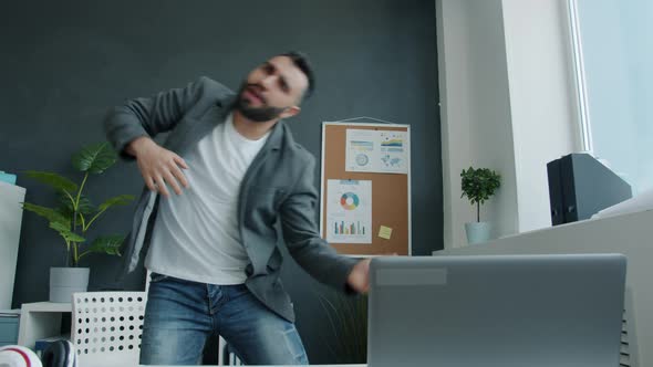 Joyful Middleaged Employee in Trendy Clothing Dancing Enjoying Break in Workplace