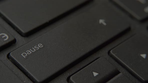 Finger Presses Pause Button on Keyboard