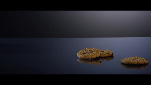 Falling cookies from above onto a reflective surface - COOKIES 194