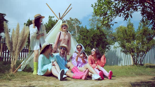 Group of young Asian friends wearing colorful casual dress camping