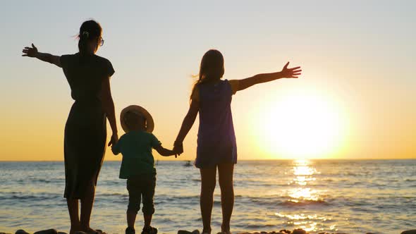 Happy Family Mother with Two Children on Vacation at the Beach