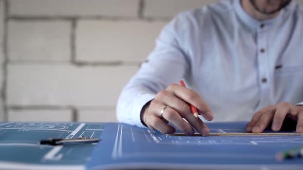 Close Up Of Architect Hands Drawing Blueprints