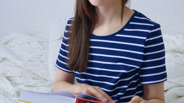 A Woman Reads a Book Gets the Information She Needs and Enjoys Reading the Book