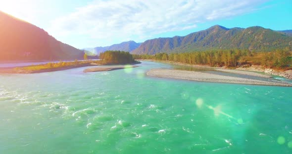 UHD Aerial View, Low Flight Over Fresh Cold Mountain River at Sunny Summer Morning, Green Trees and