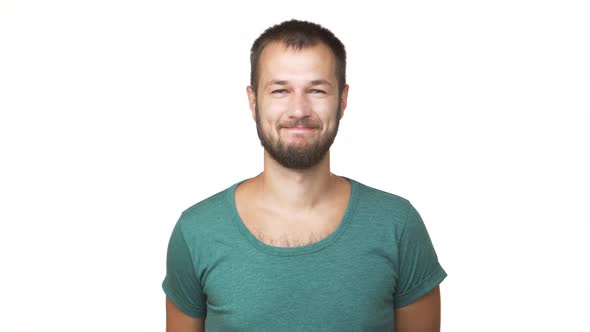 Horizontal Portrait of Optimistic Bearded Man Wearing Shirt Looking on Camera Smiling Showing Hand