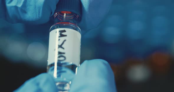 Laboratory Technician working with small bottles