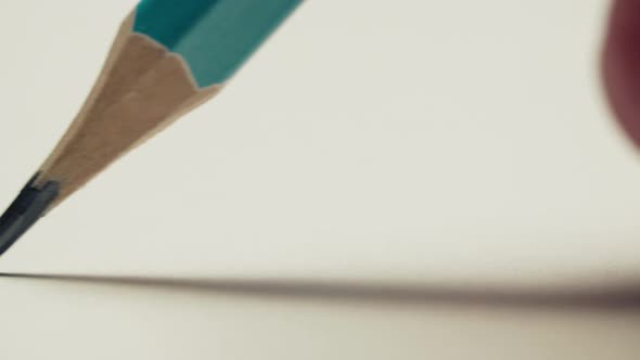 Graphite Pencil Draws a Straight Line on a White Background Paper, Macro Shot alt